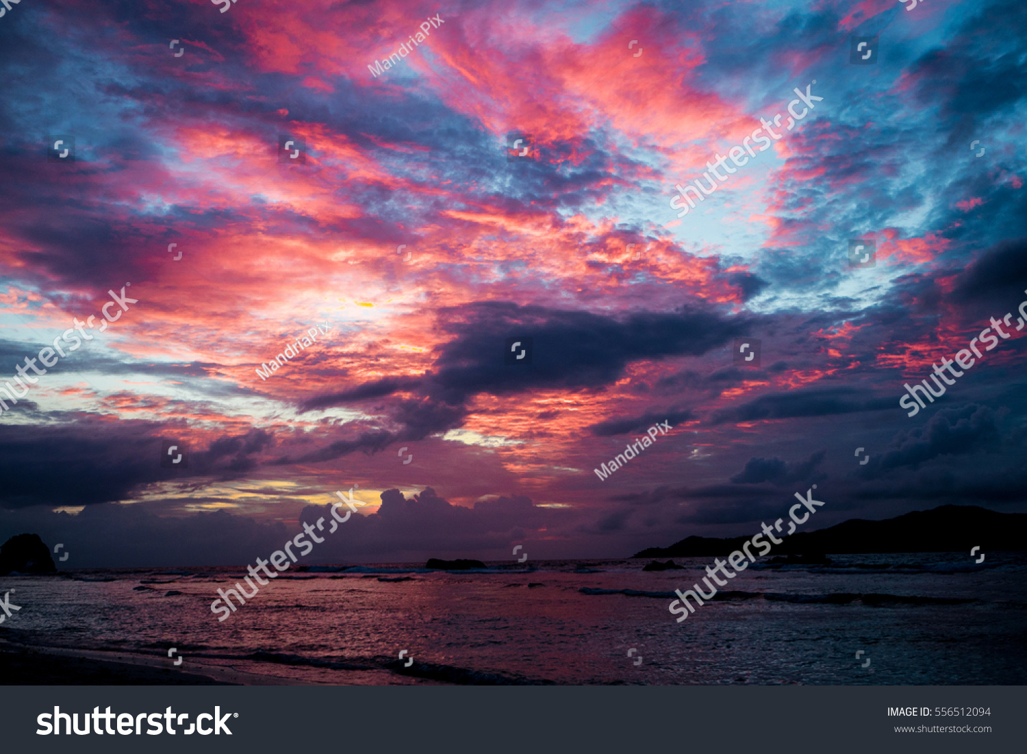 Sunset seascape with dramatic sky and colorful clouds #556512094