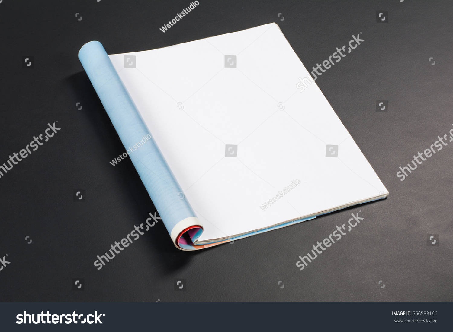 Mock-up magazine or catalog on black chalkboard. Blank page or notepad on black table background. Blank page or notepad for mockups or simulations. #556533166