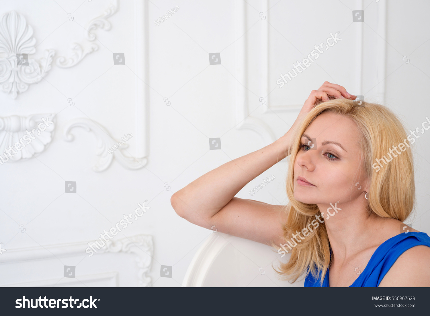 Portrait of a beautiful blonde woman on a light background #556967629