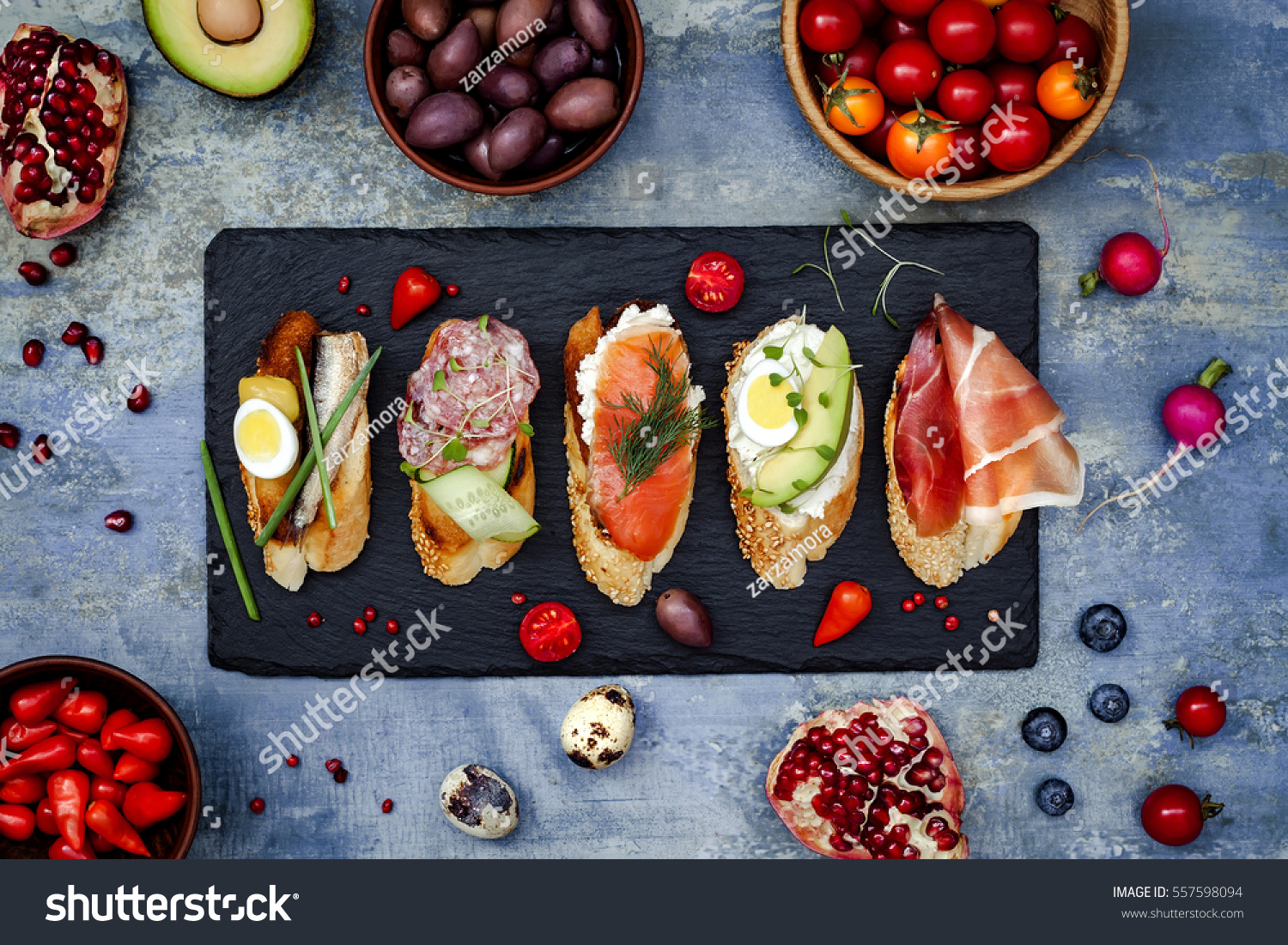 Mini sandwiches food set. Brushetta or authentic traditional spanish tapas for lunch table. Delicious snack, appetizer, antipasti on party or picnic time. Top view. #557598094