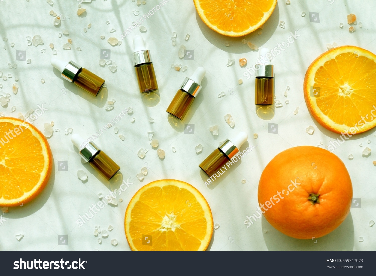 Cosmetic brown bottle containers with fresh orange slices, Blank label for branding mock-up, Natural Vitamin C beauty product concept. (Color Processed) #559317073
