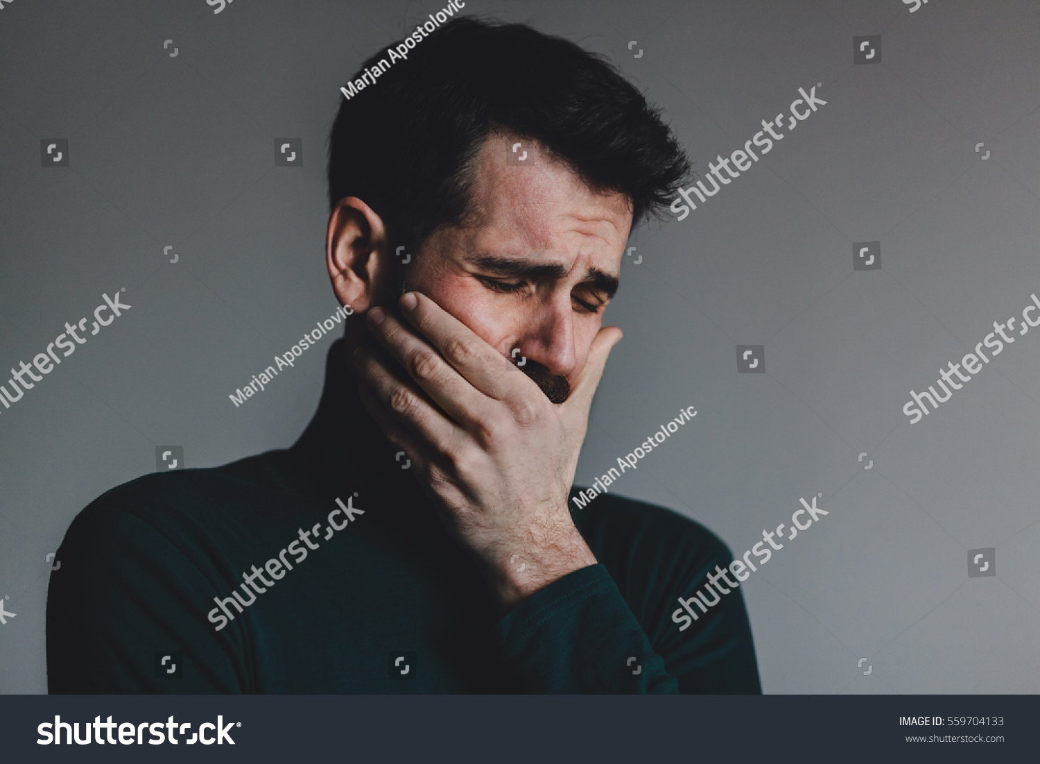 Young man with a problem crying #559704133