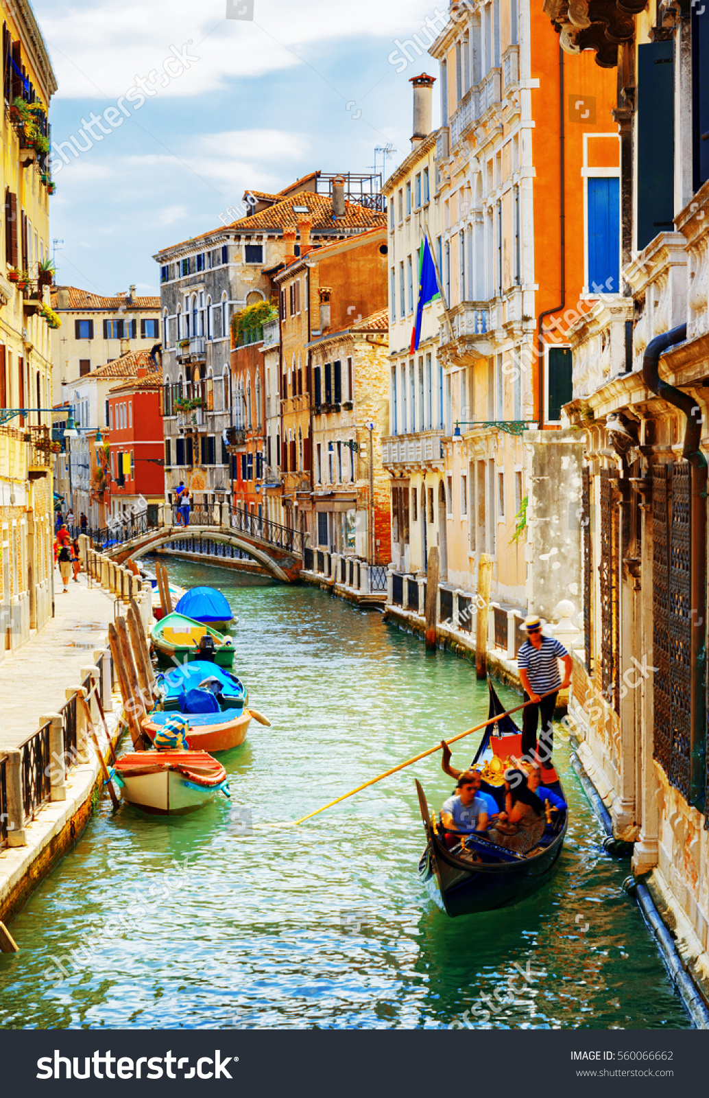 Tourists traveling in gondola. View of the Rio Marin Canal with boats from the Ponte de la Bergami in Venice, Italy. Venice is a popular tourist destination of Europe. #560066662