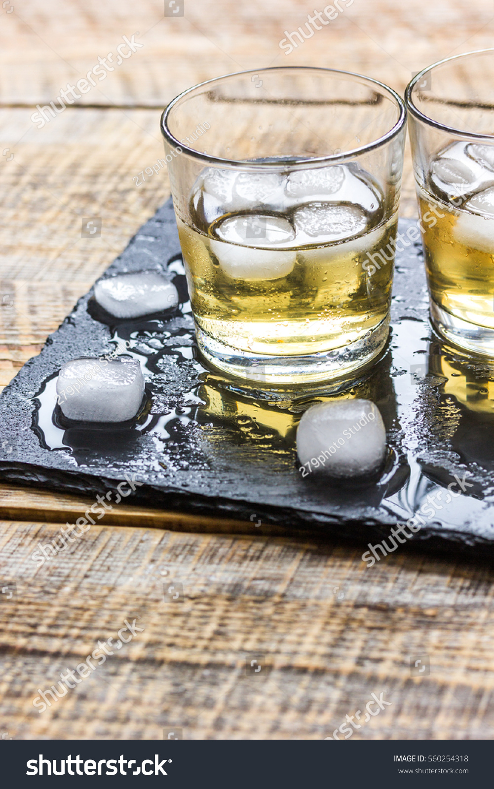 glass of whiskey on wooden background #560254318