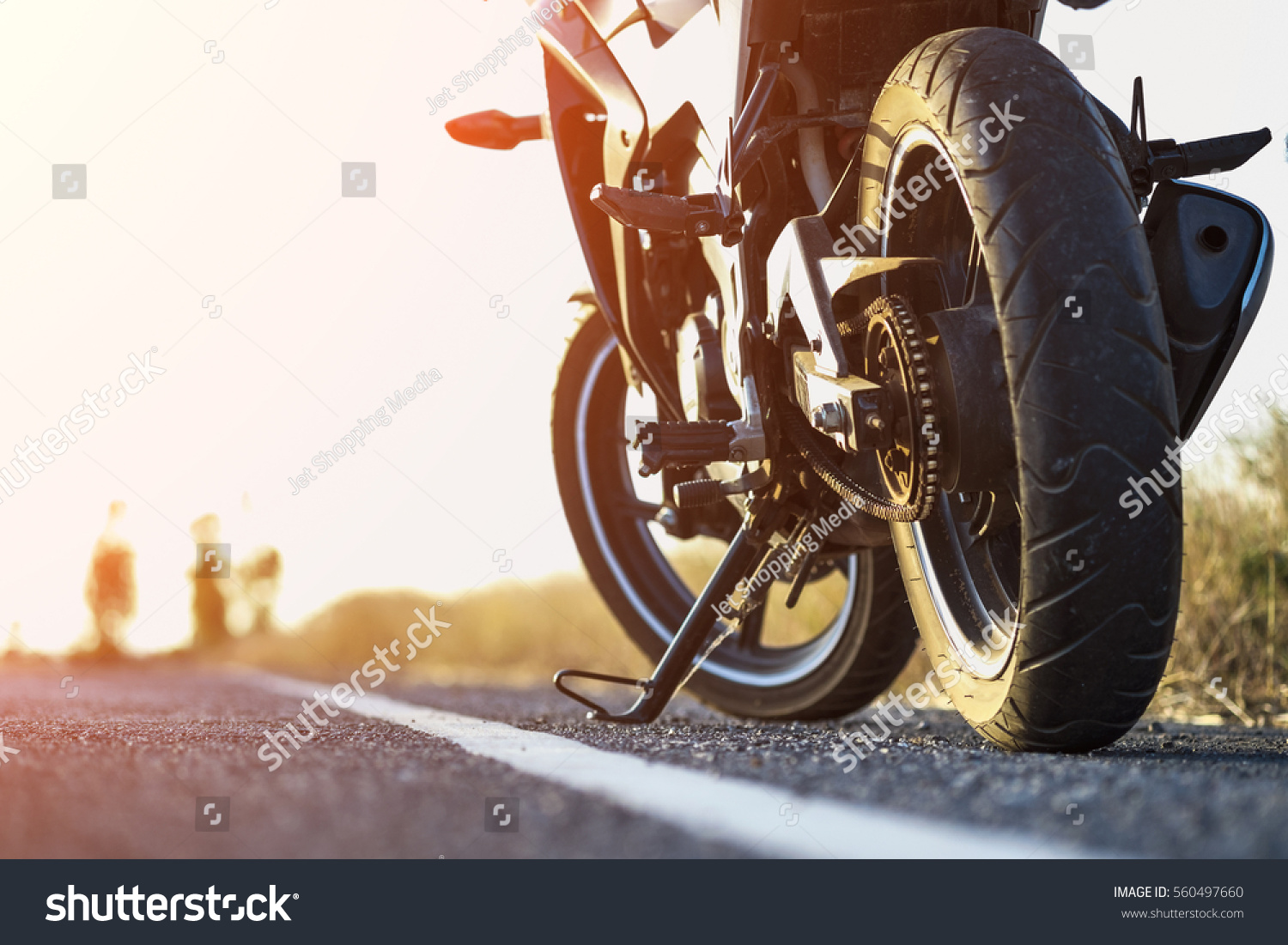 A motorcycle parking on the road right side and sunset, select focusing background. #560497660