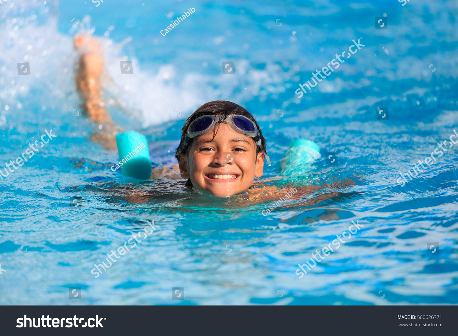 Boy happy swimming in a pool  #560626771