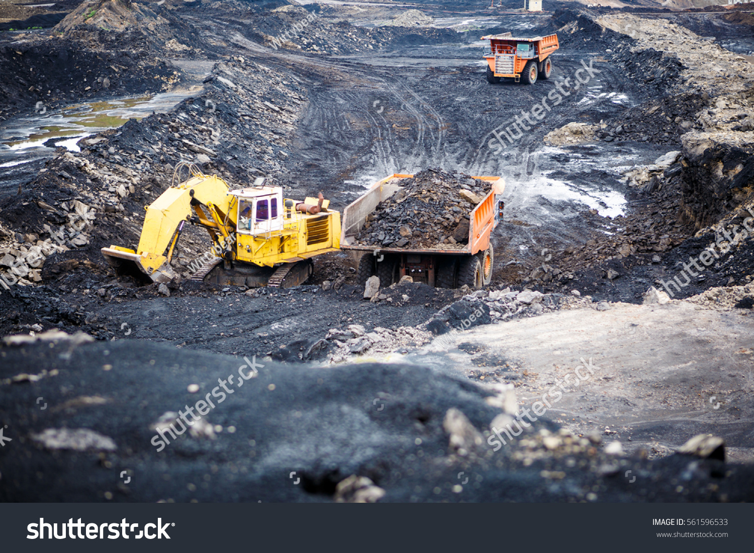 Mining dump trucks working in Lignite coalmine #561596533