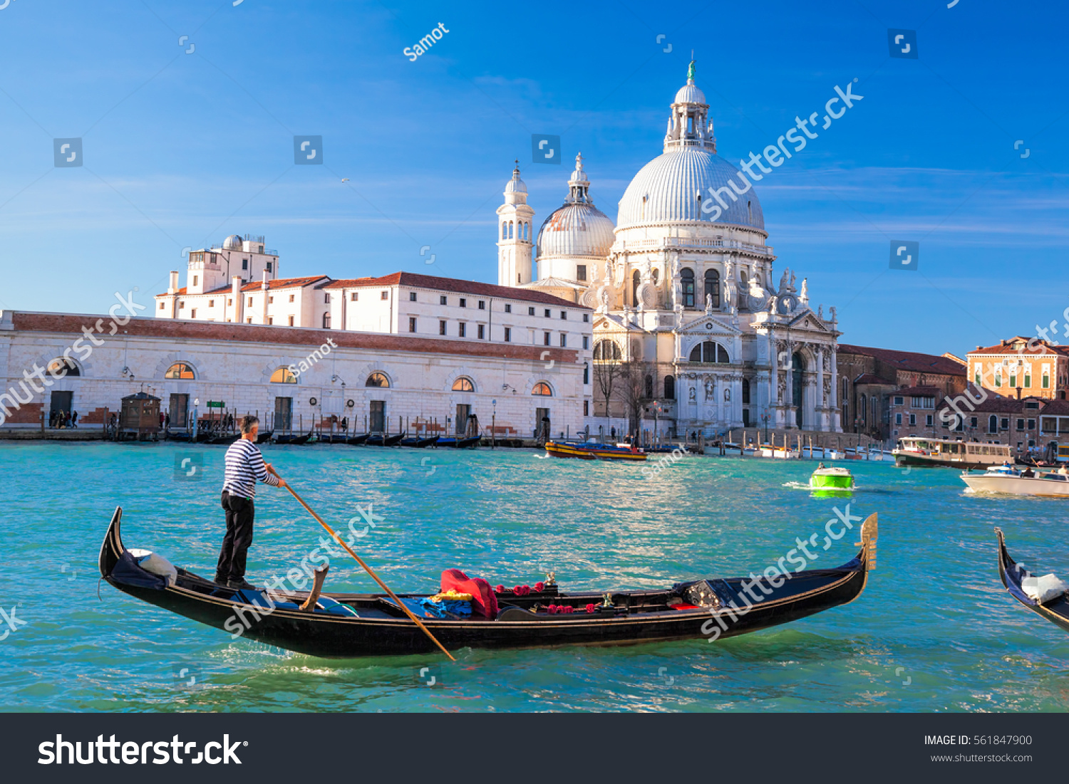 Grand Canal with gondola against Basilica Santa Maria della Salute in Venice, Italy #561847900
