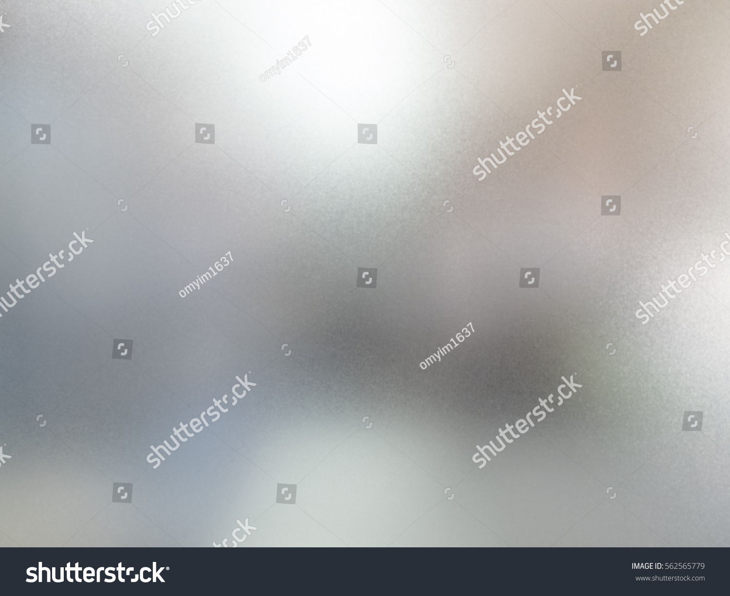 detail of sand glass window with blurred background behind #562565779