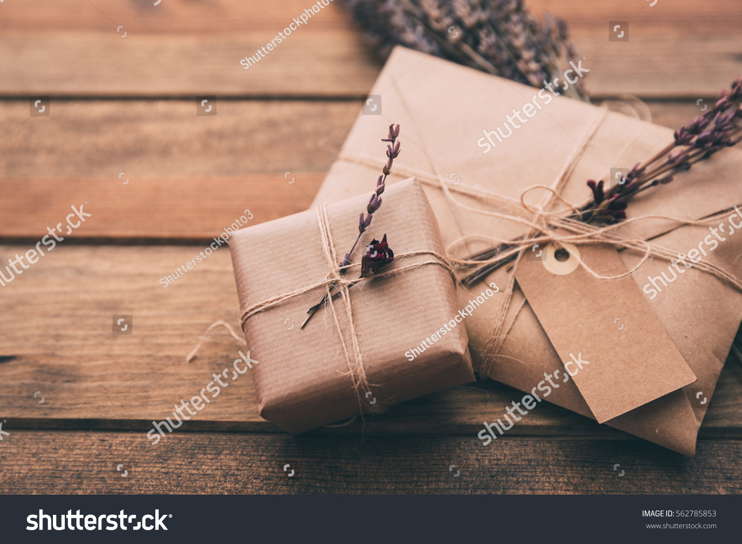 Gift wrapping composition. homemade wrapped  present boxes, decoration and tools on wooden background. above view, flat lay #562785853