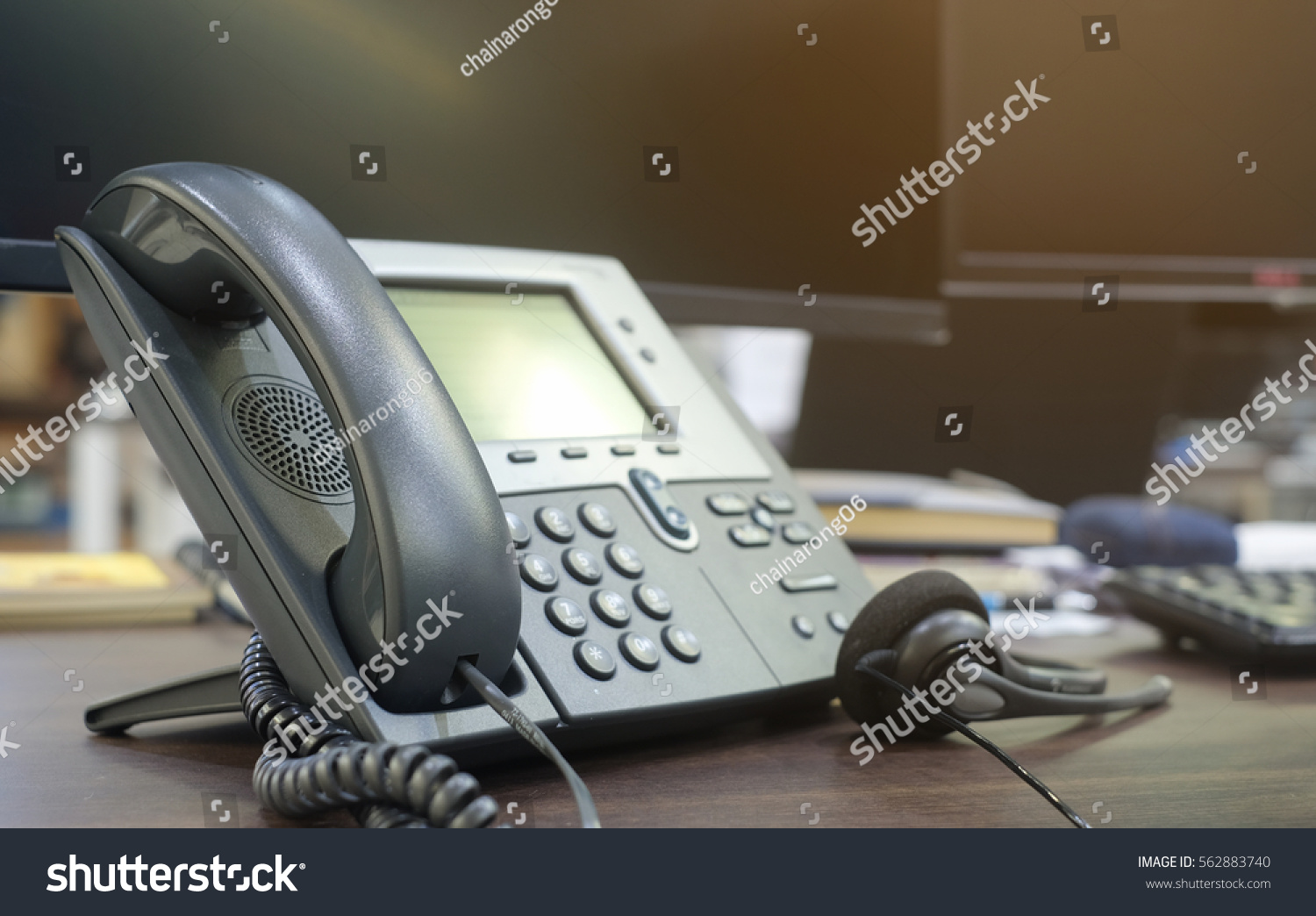 close up soft focus on telephone devices at office desk for customer service support concept #562883740
