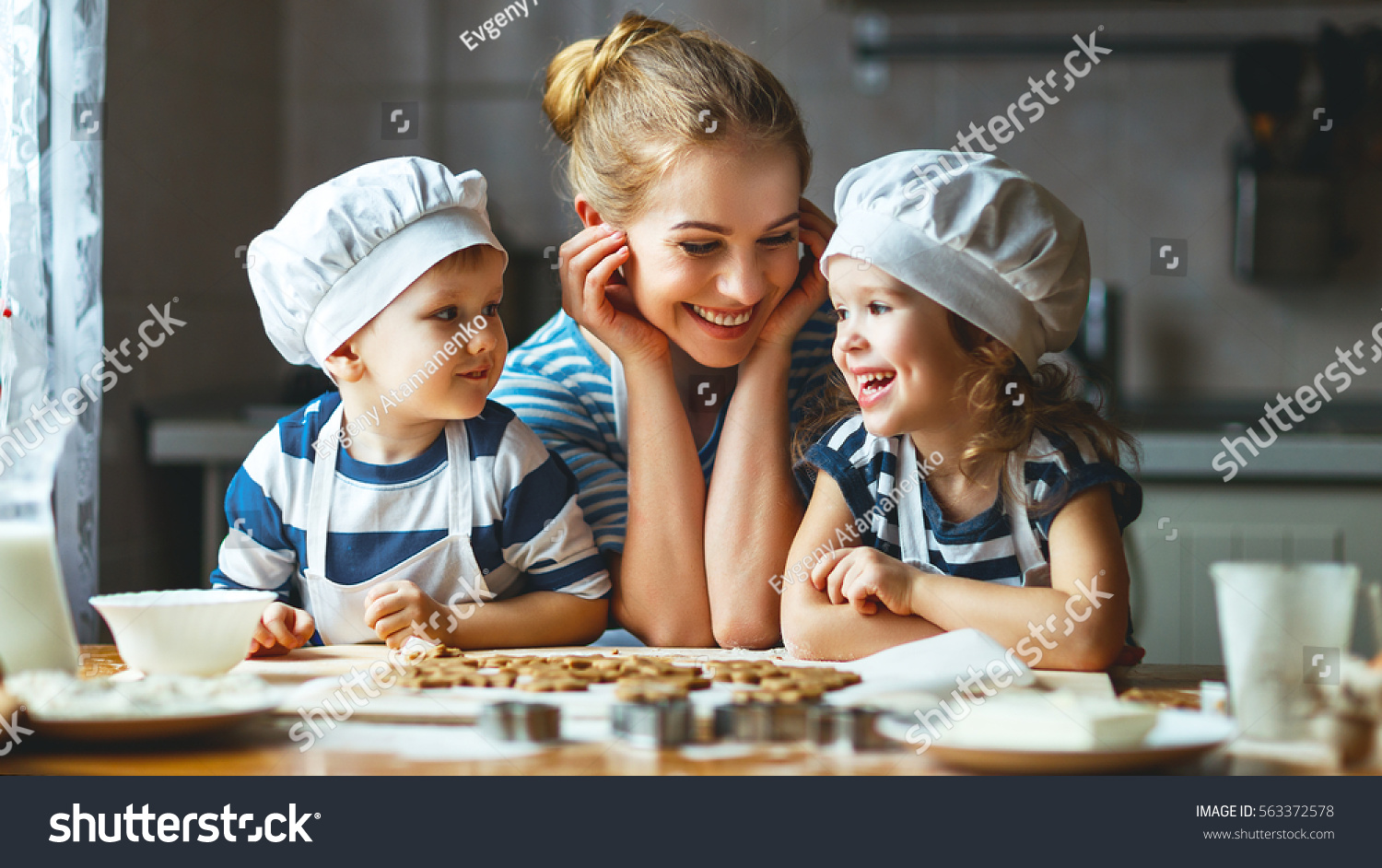 happy family in the kitchen. mother and  children preparing the dough, bake cookies
 #563372578