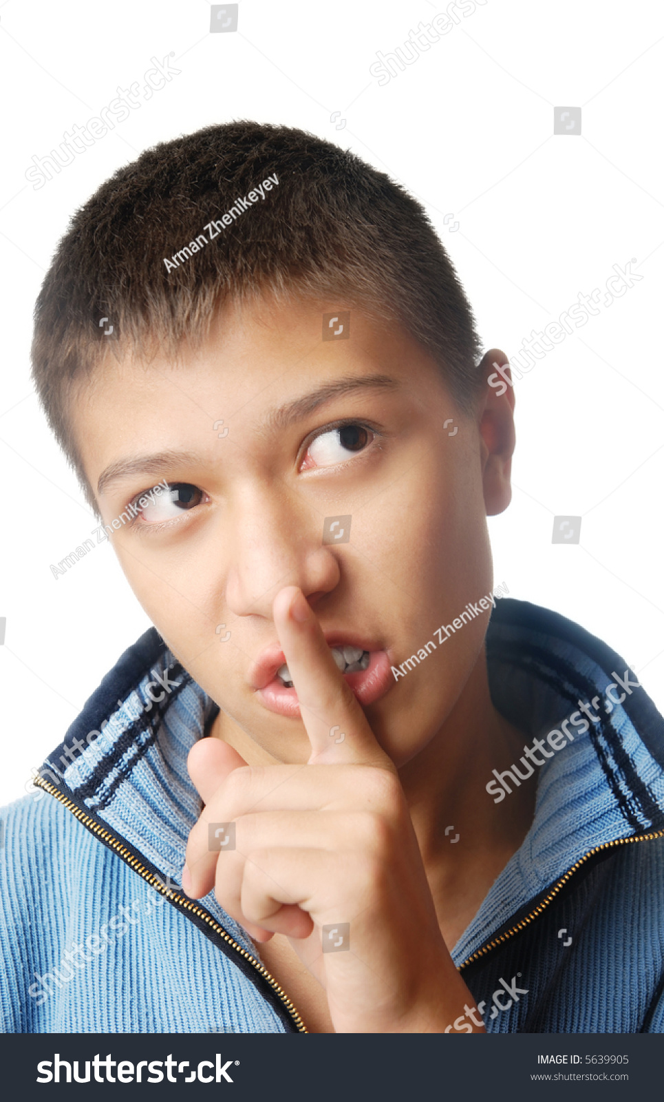 Photo of the boy with finger on his lips as a symbol of silence #5639905