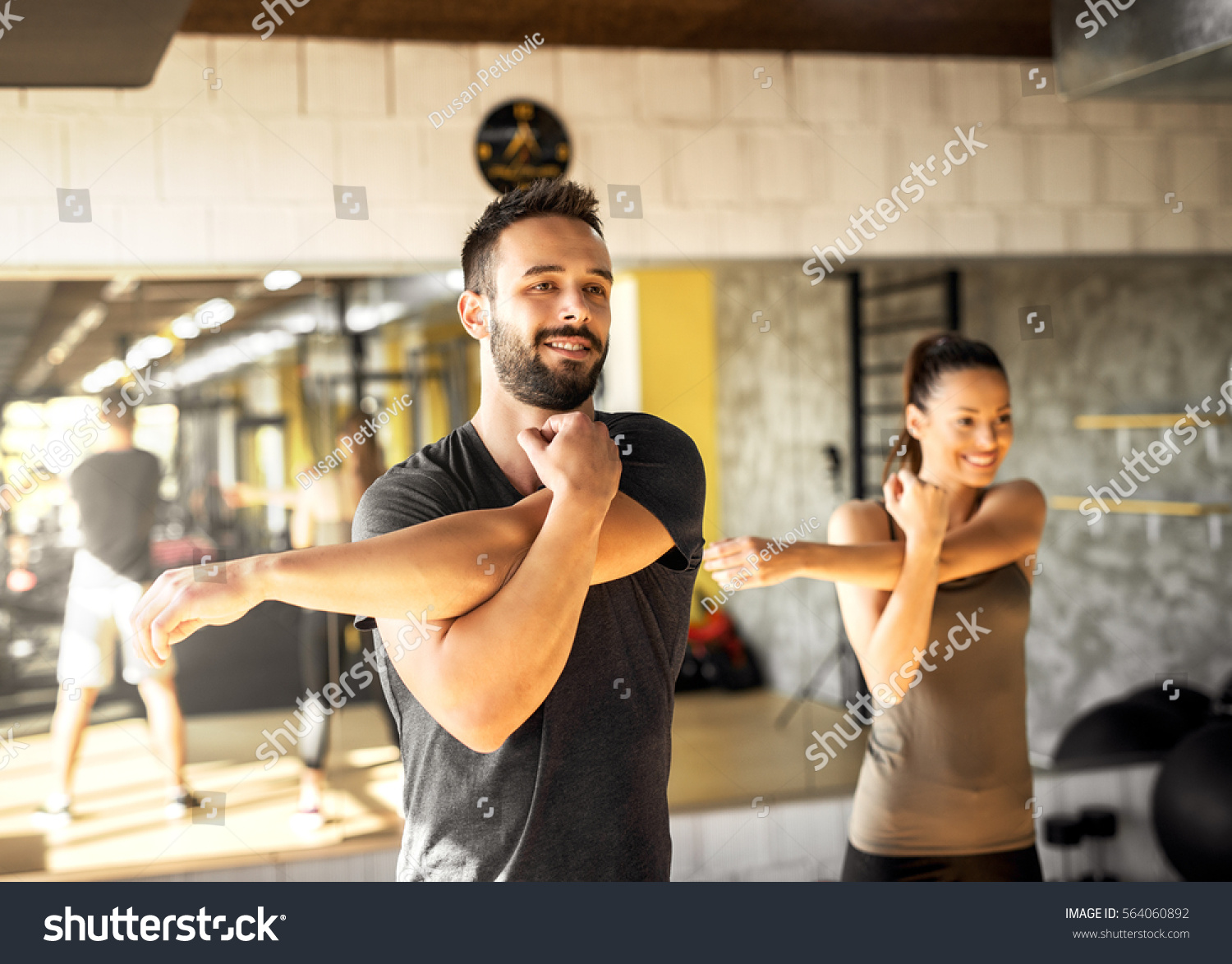 Healthy athletes exercising at gym. #564060892