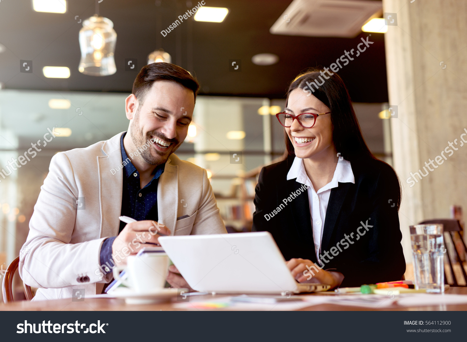 Two young businessman having a successful meeting at restaurant. #564112900