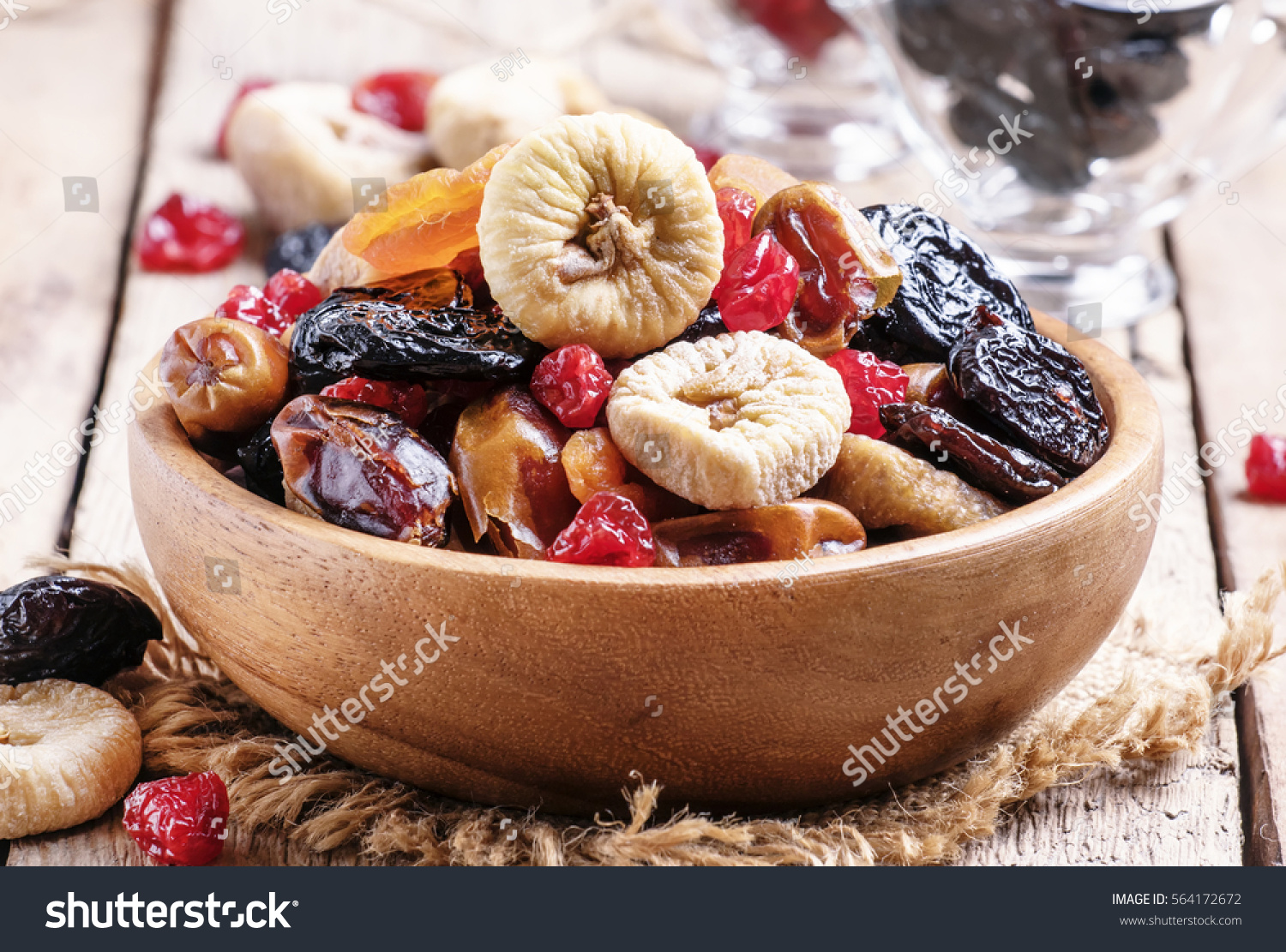 Healthy food: mix from dried fruits in bowl, old wooden background, selective focus #564172672