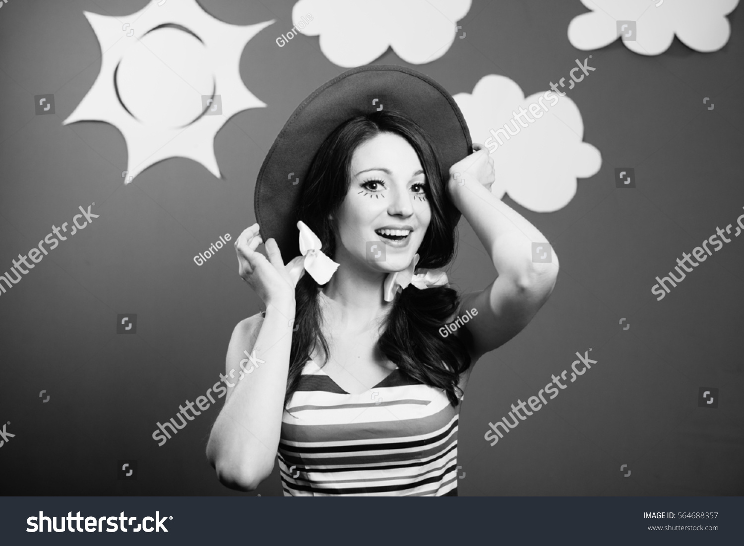Black and white portraitt of amazed excited young woman actress on the theatrical play handmade sky background #564688357