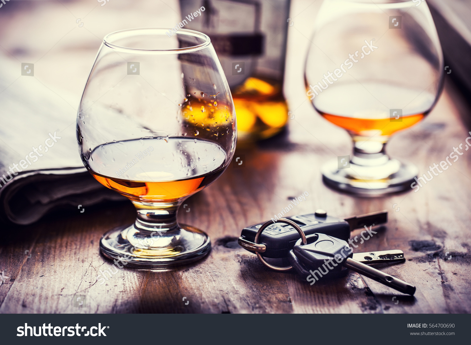 Two cups of cognac brandy or rum with car keys. #564700690