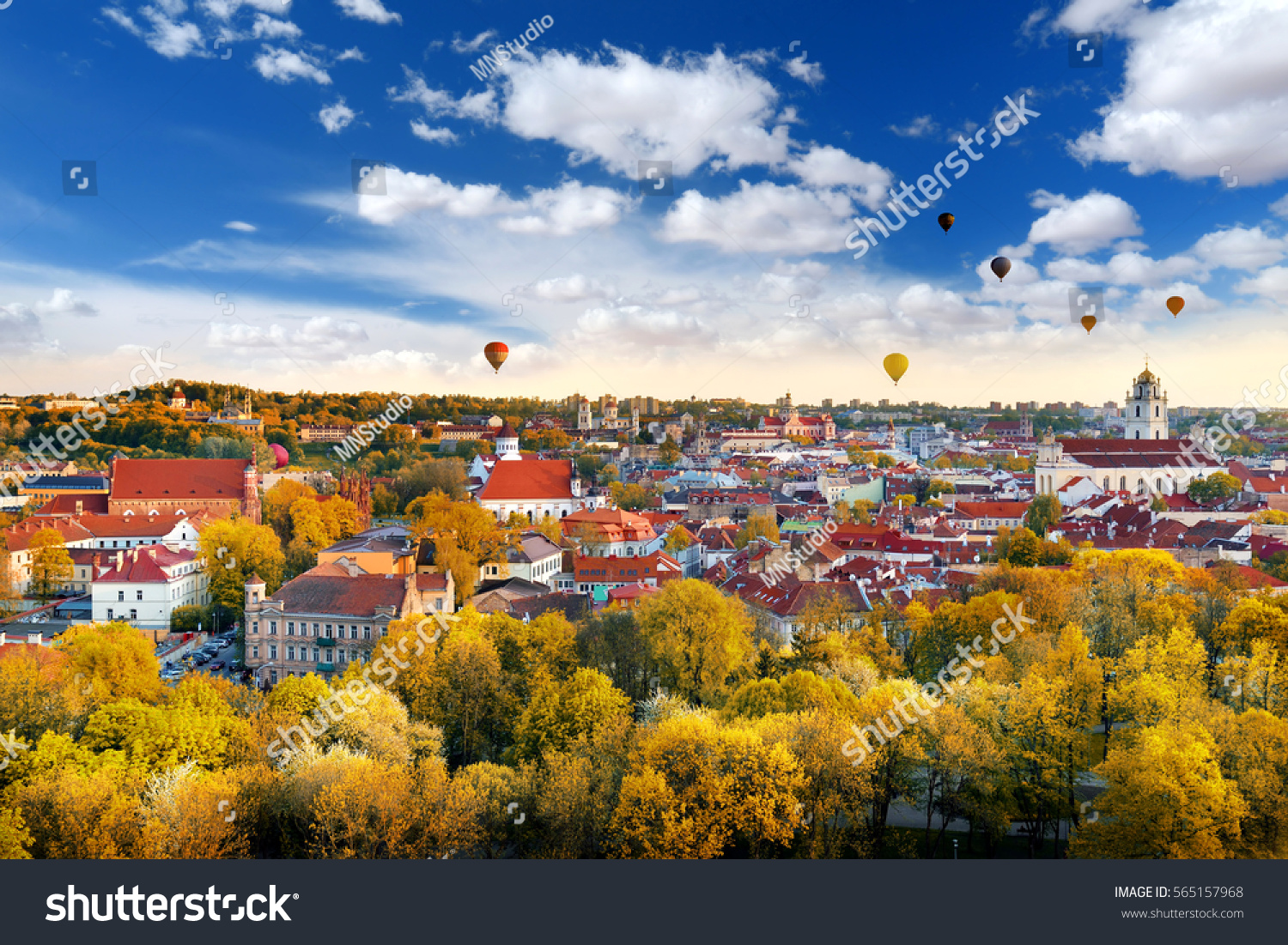 Beautiful autumn panorama of Vilnius old town with colorful hot air balloons in the sky, taken from the Gediminas hill  #565157968