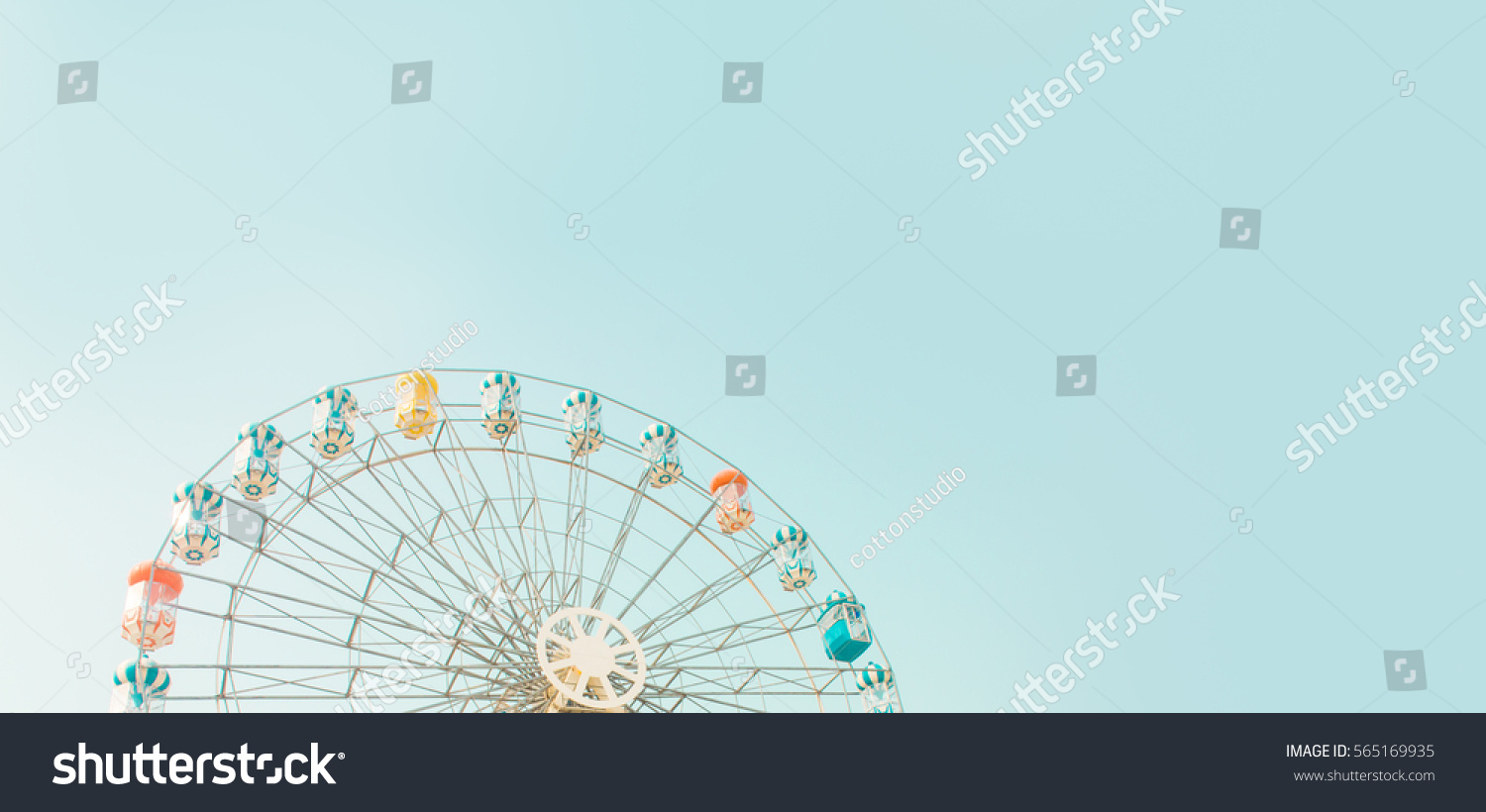 Retro colorful ferris wheel of the amusement park in the blue sky  background. #565169935