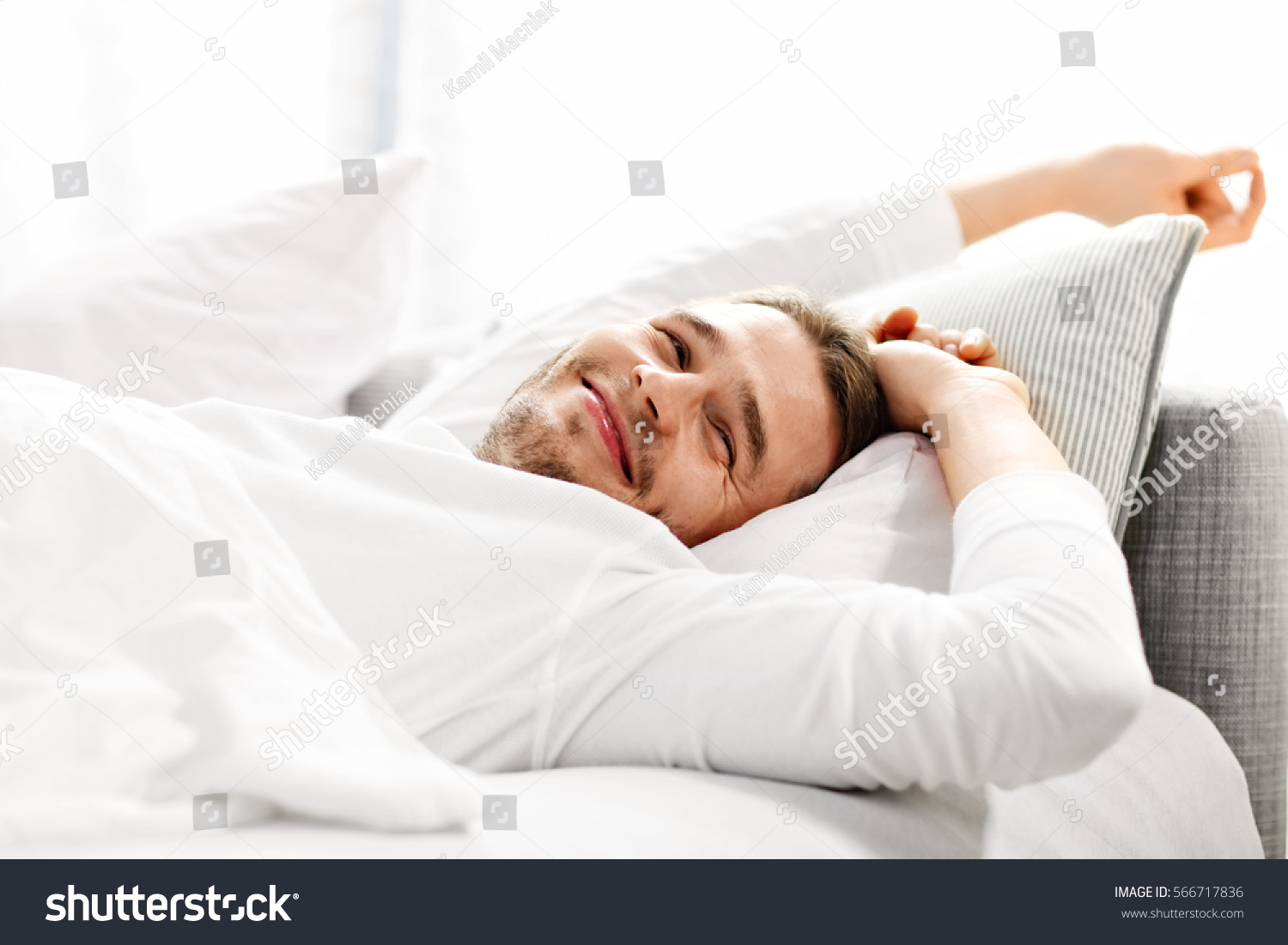 Picture showing young man stretching in bed #566717836