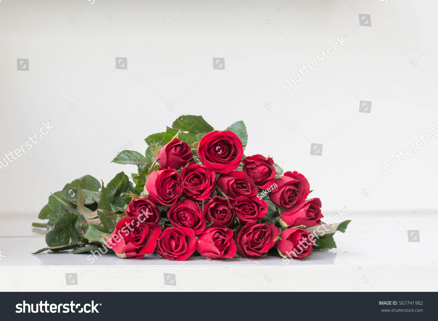 Red roses on white table for valentine's day #567741982