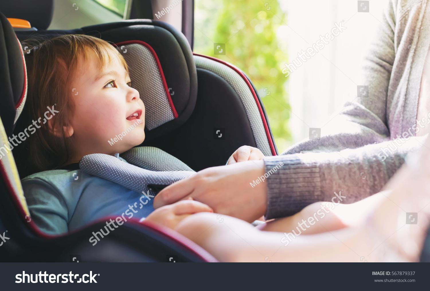 Toddler girl buckled into her car seat #567879337