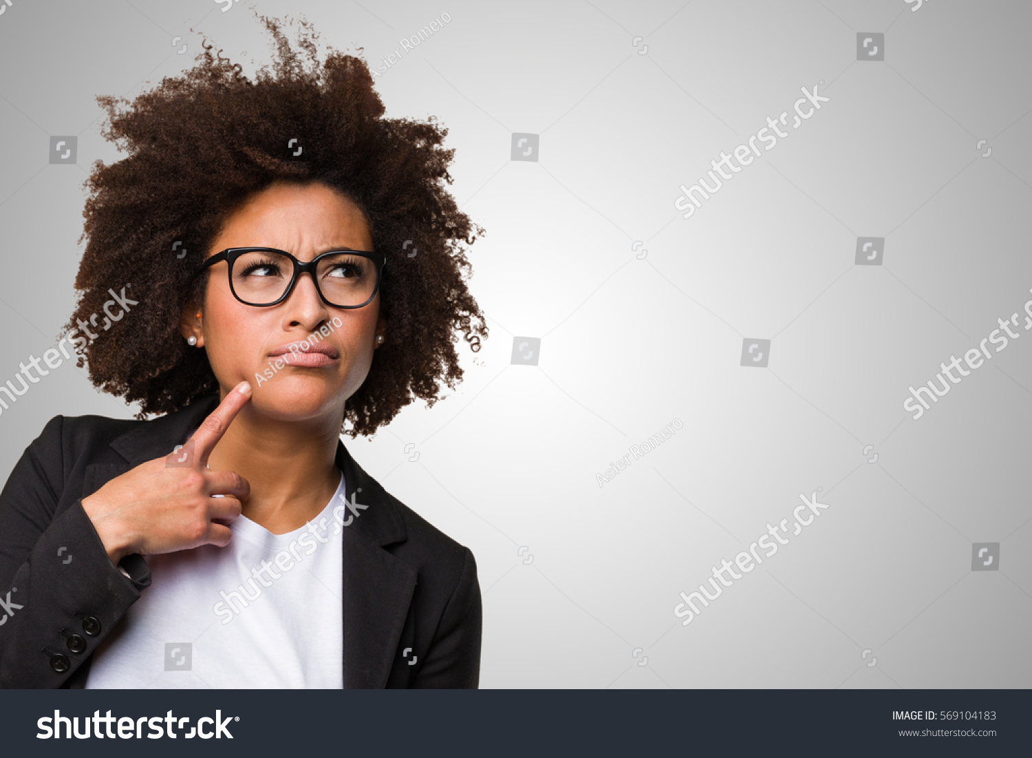 business black woman thinking on a grey background #569104183