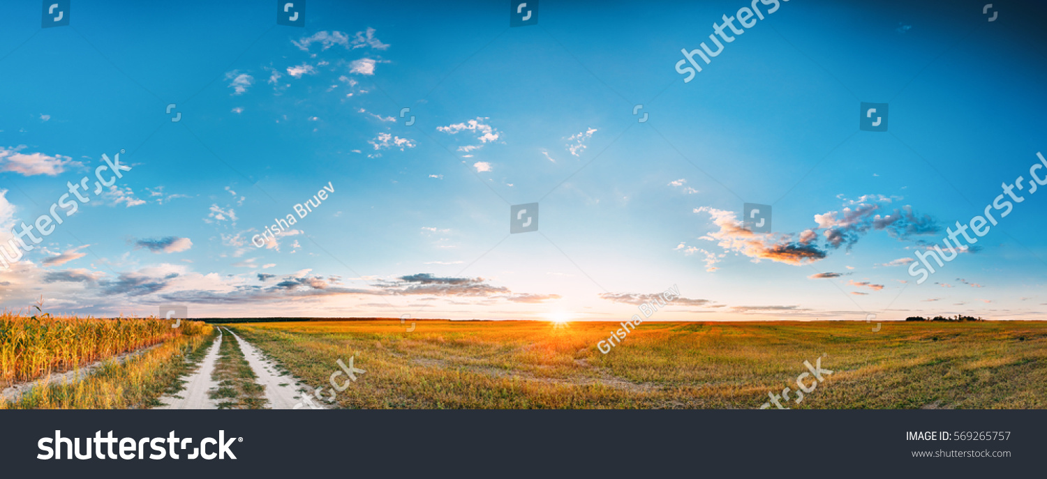 Sunset, Sunrise Over Rural Meadow Field And Country Open Road. Countryside Landscape With Path Way Under Scenic Summer Dramatic Sky In Sunset Dawn Sunrise. Sun Over Skyline Or Horizon. #569265757