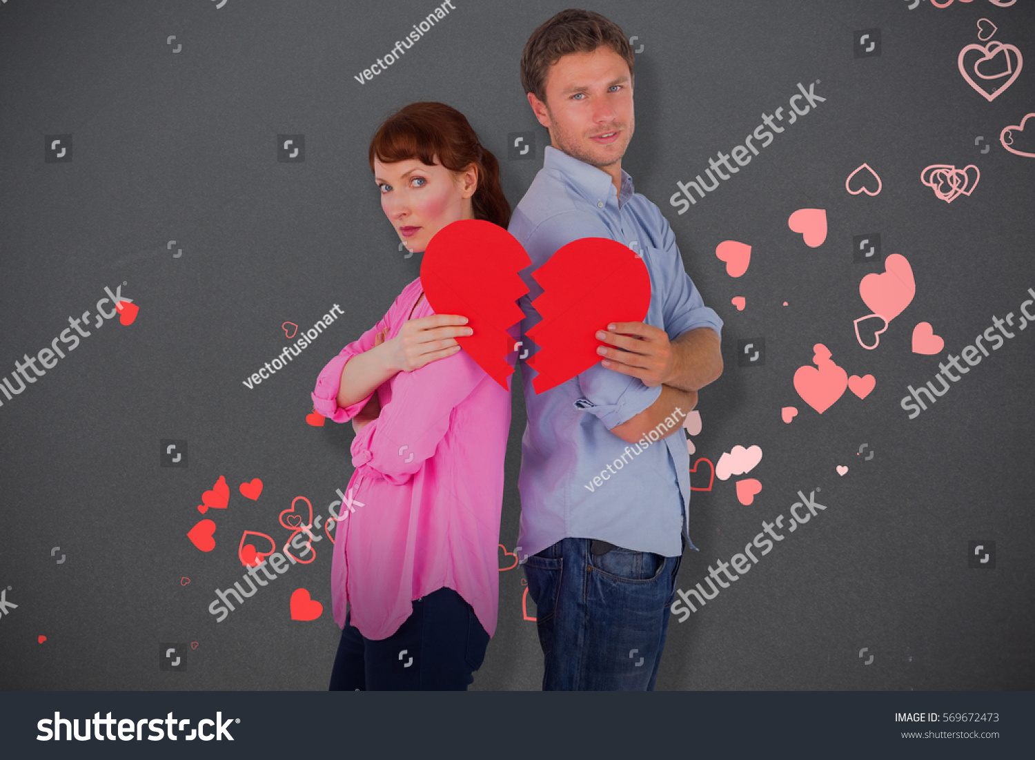 Couple holding a broken heart against grey #569672473