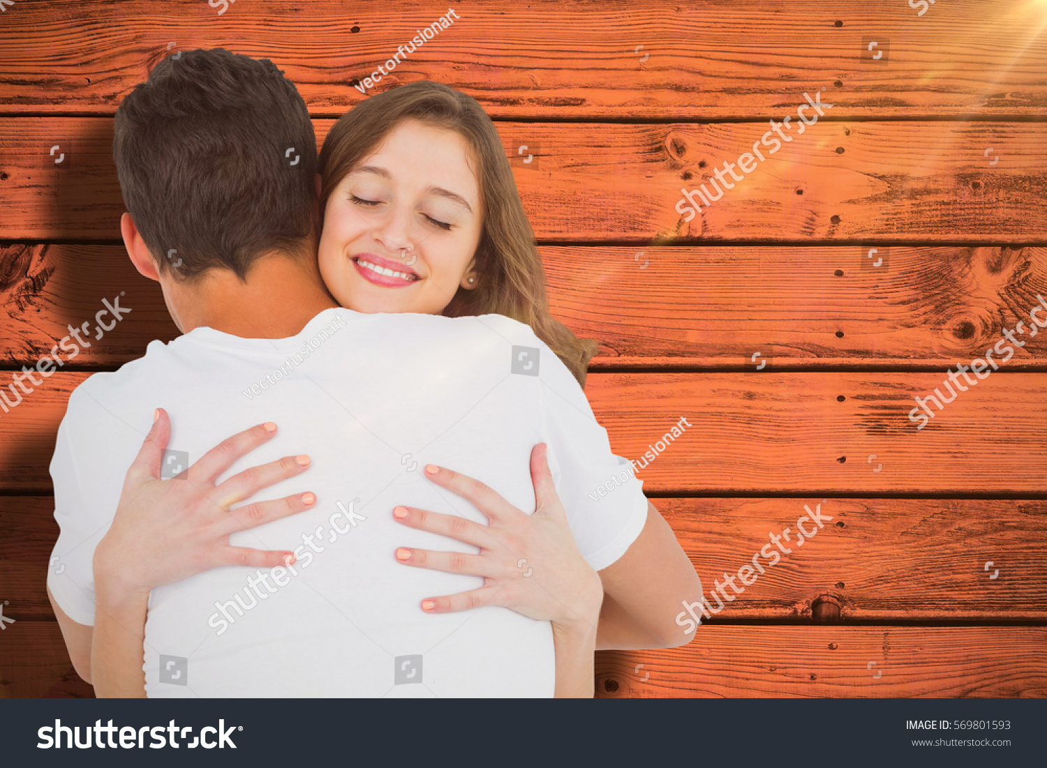 Close up of couple hugging against pink paint splashed surface #569801593