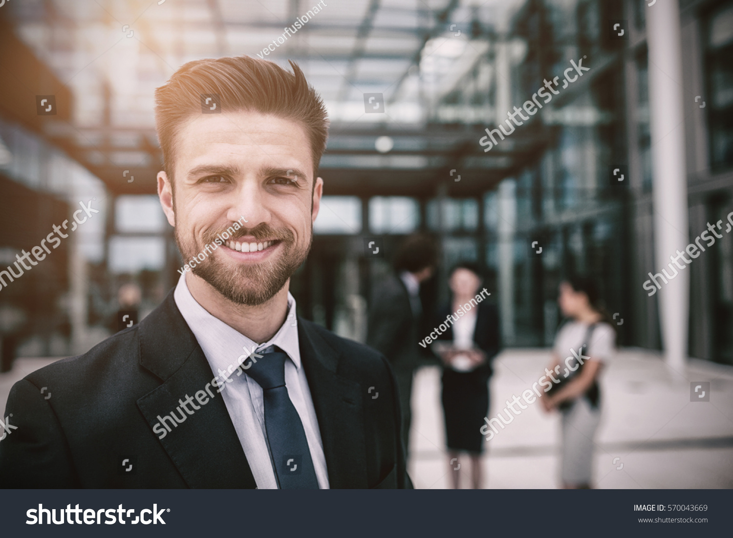 Portrait of happy businessman in office premises #570043669