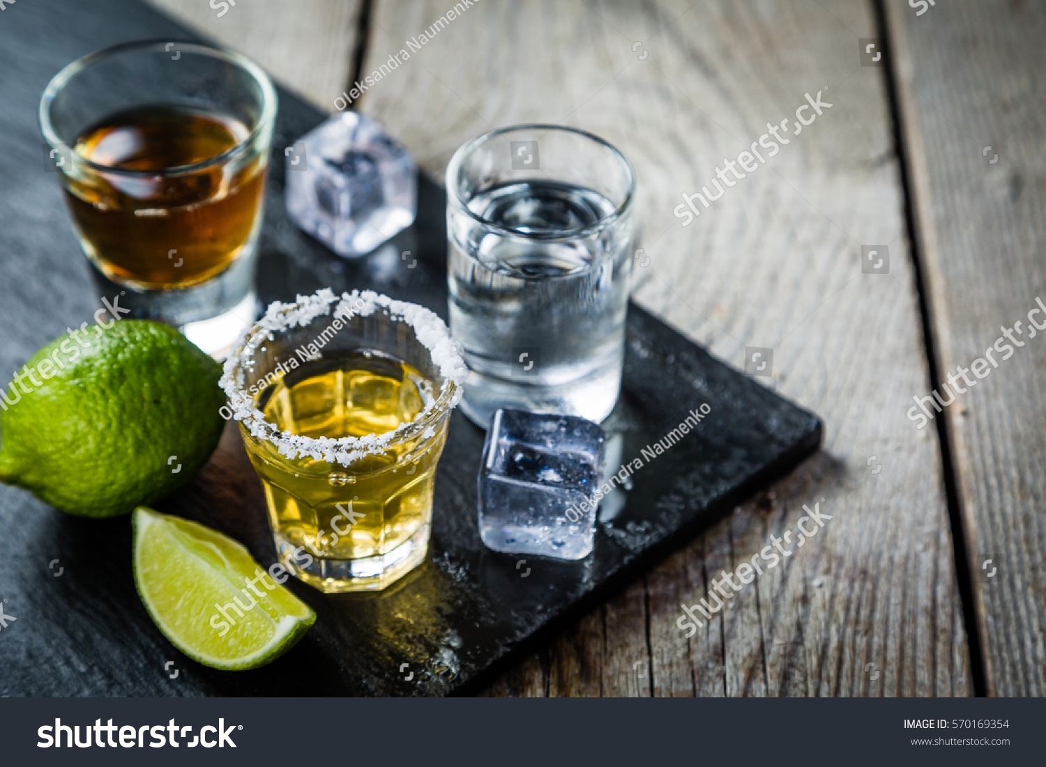 Selection of alcoholic drinks on rustic wood background #570169354