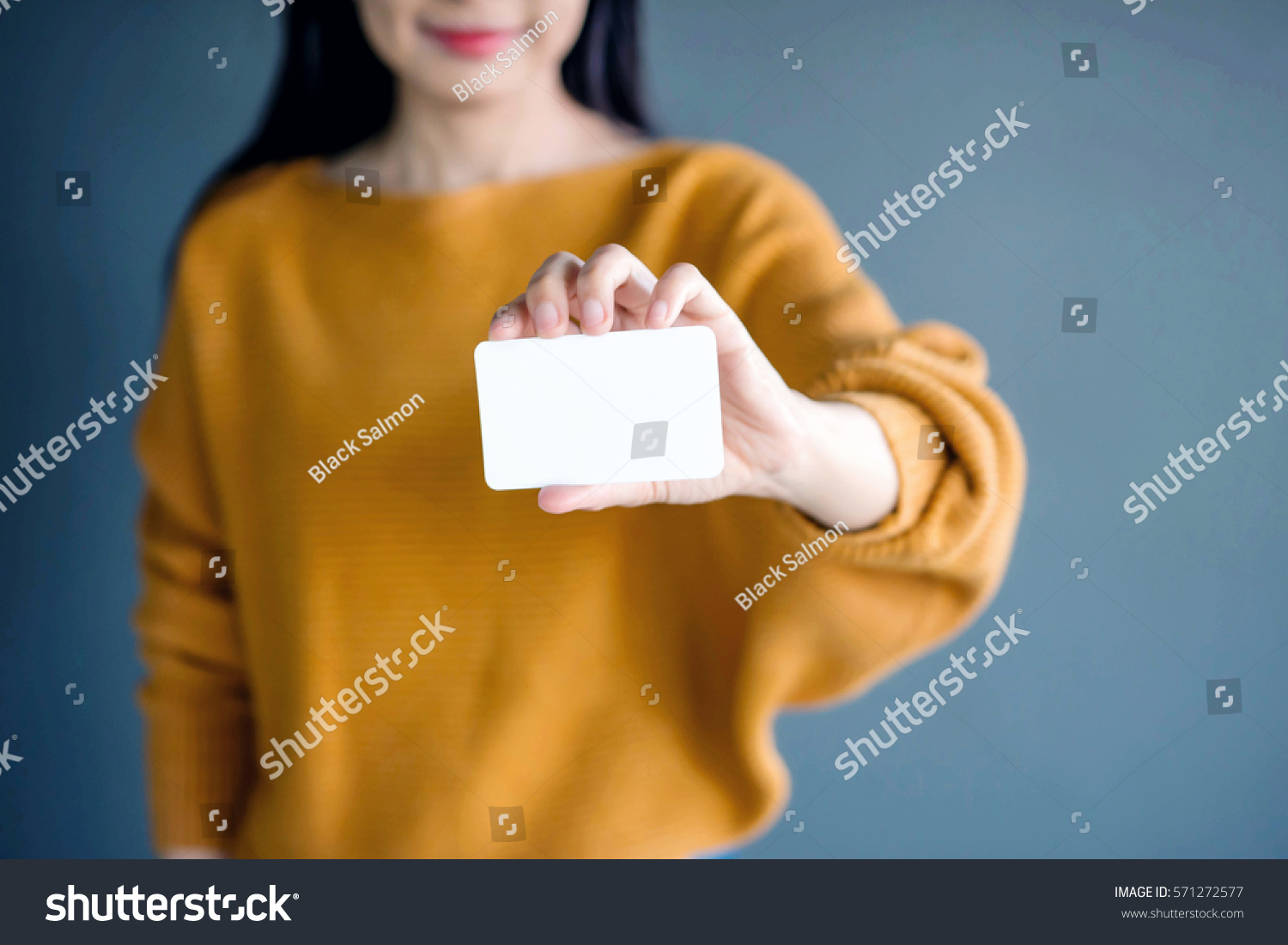 Woman holding blank business card for mock up #571272577