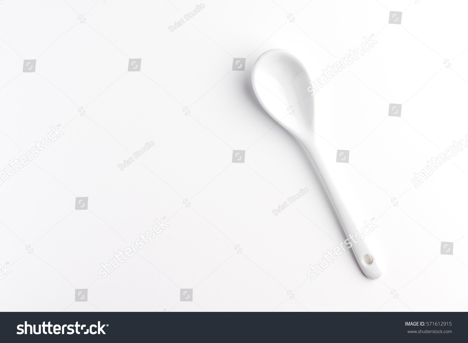White spoon isolated on a white surface #571612915