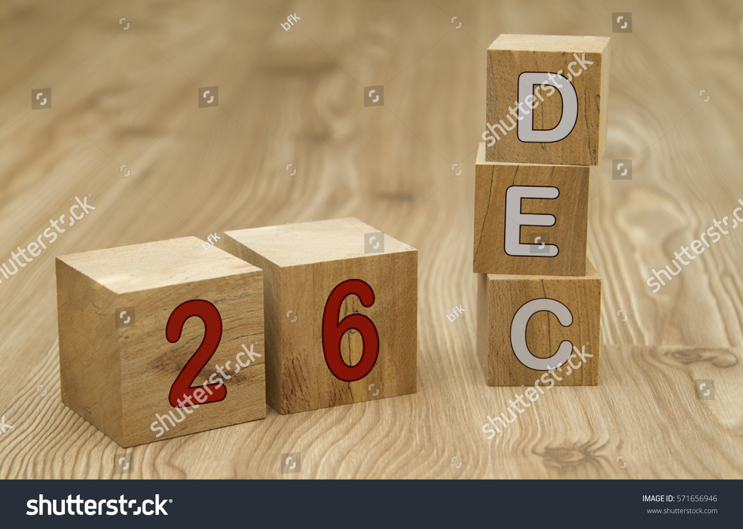 Cube shape calendar for DECEMBER 26 on wooden surface.  #571656946