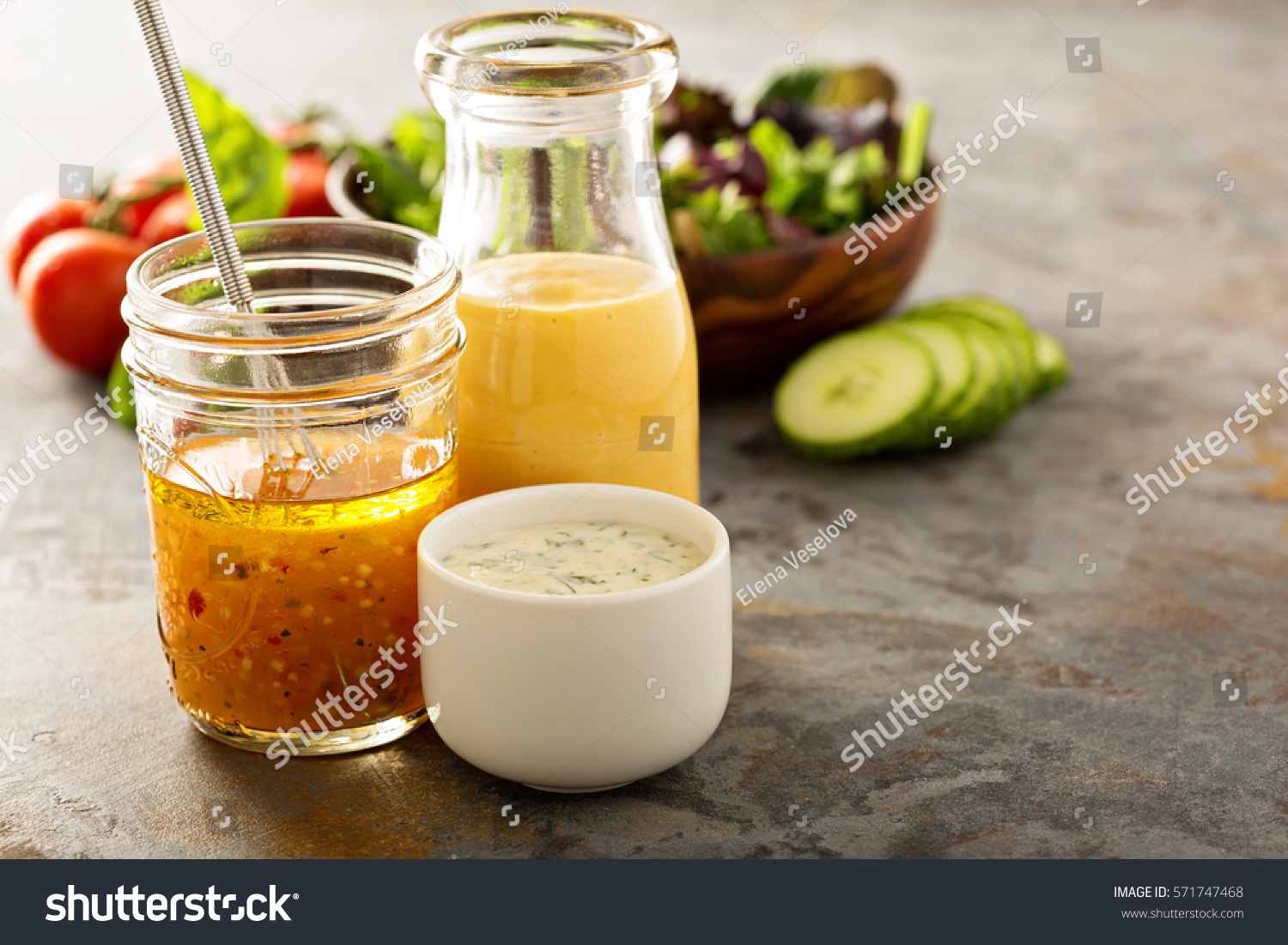 Variety of homemade sauces and salad dressings in jars including vinaigrette, ranch and honey mustard #571747468