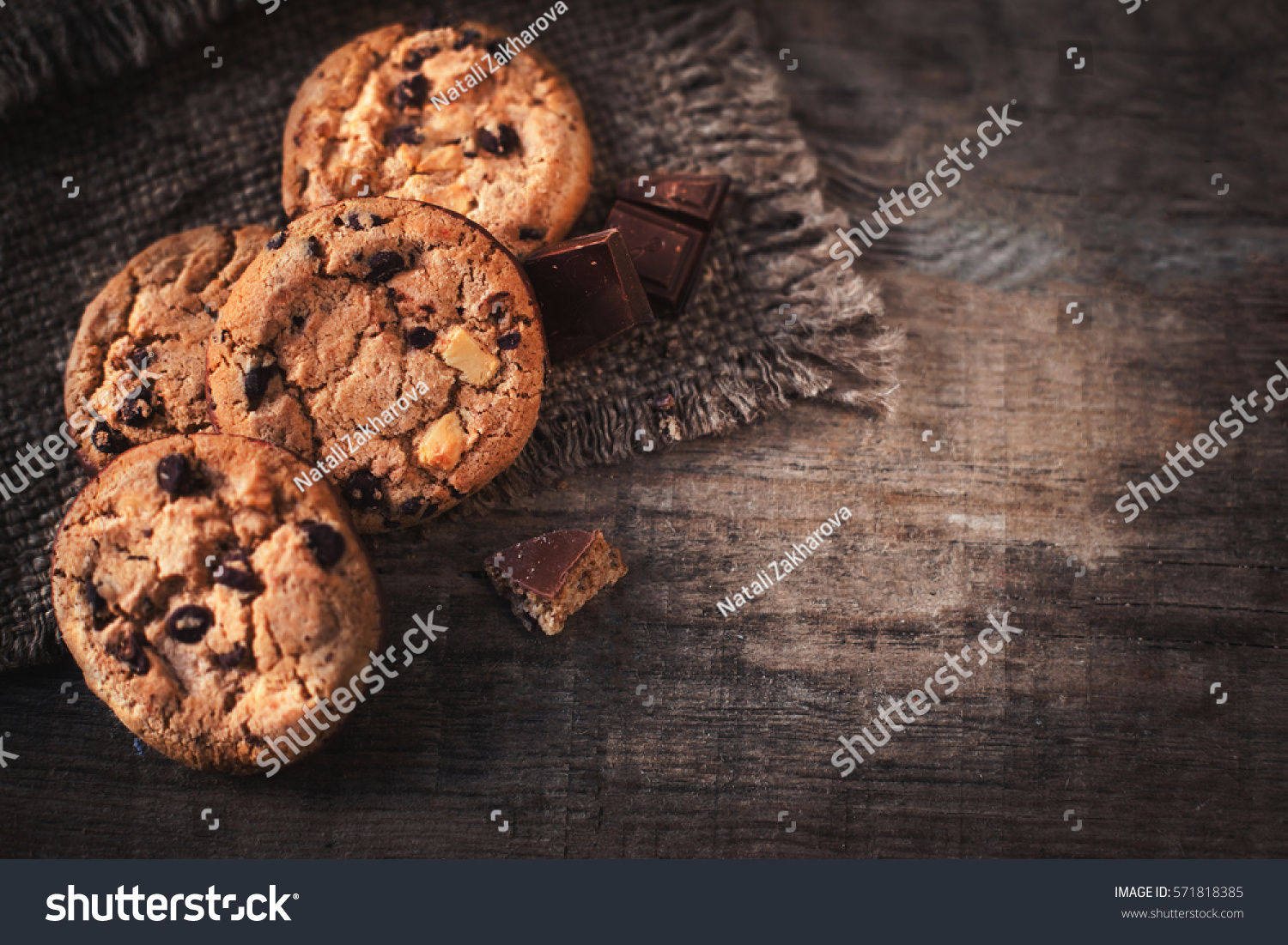 Chocolate chip cookies on dark old wooden table with place for text.,  freshly baked. Selective Focus with Copy space. #571818385