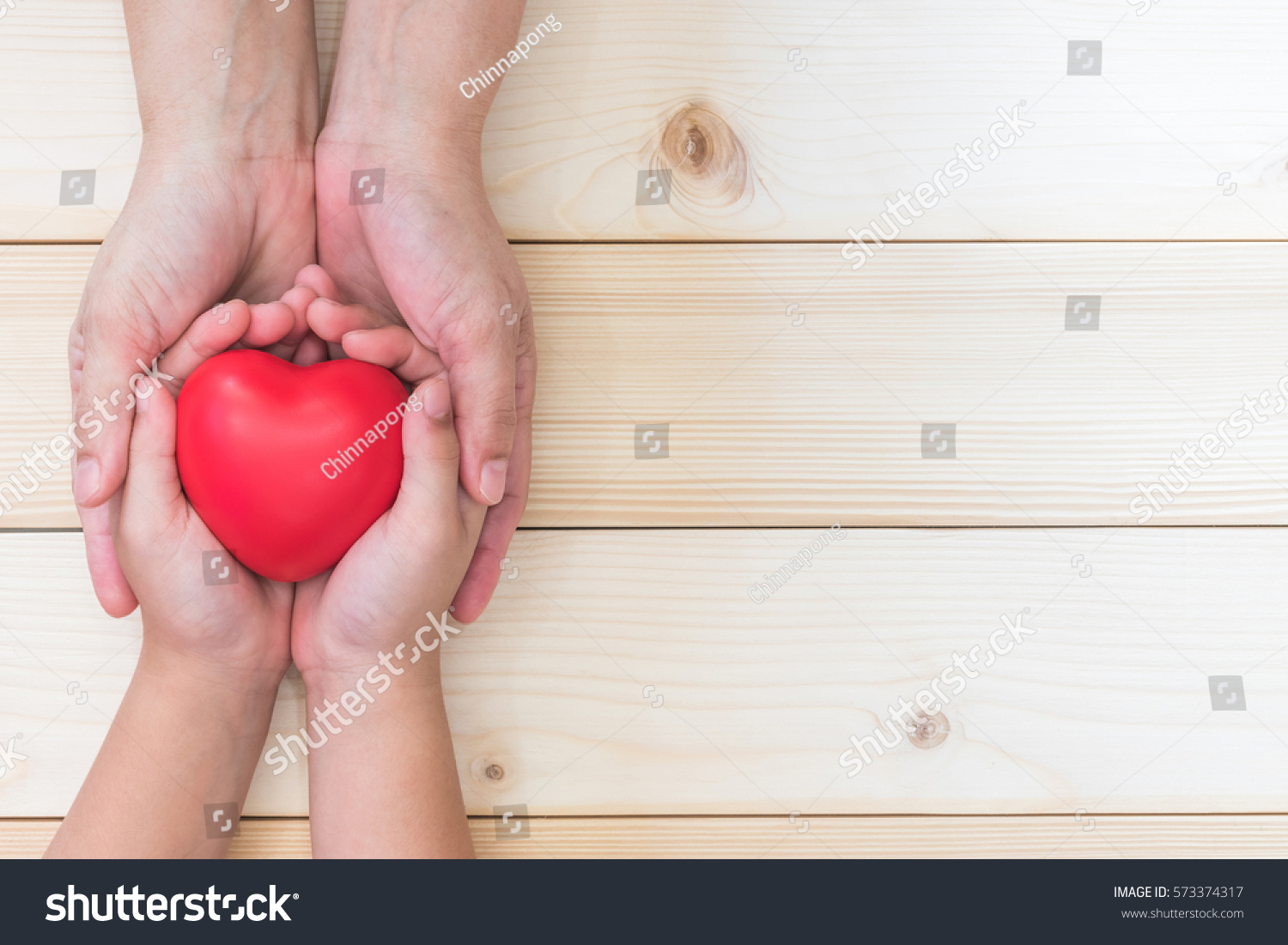 I love you Mom, Mother's Day celebration with parent woman holds young kid's hands supporting red heart, csr charity donation for nursing and parenting children adoption, family health care concept  #573374317