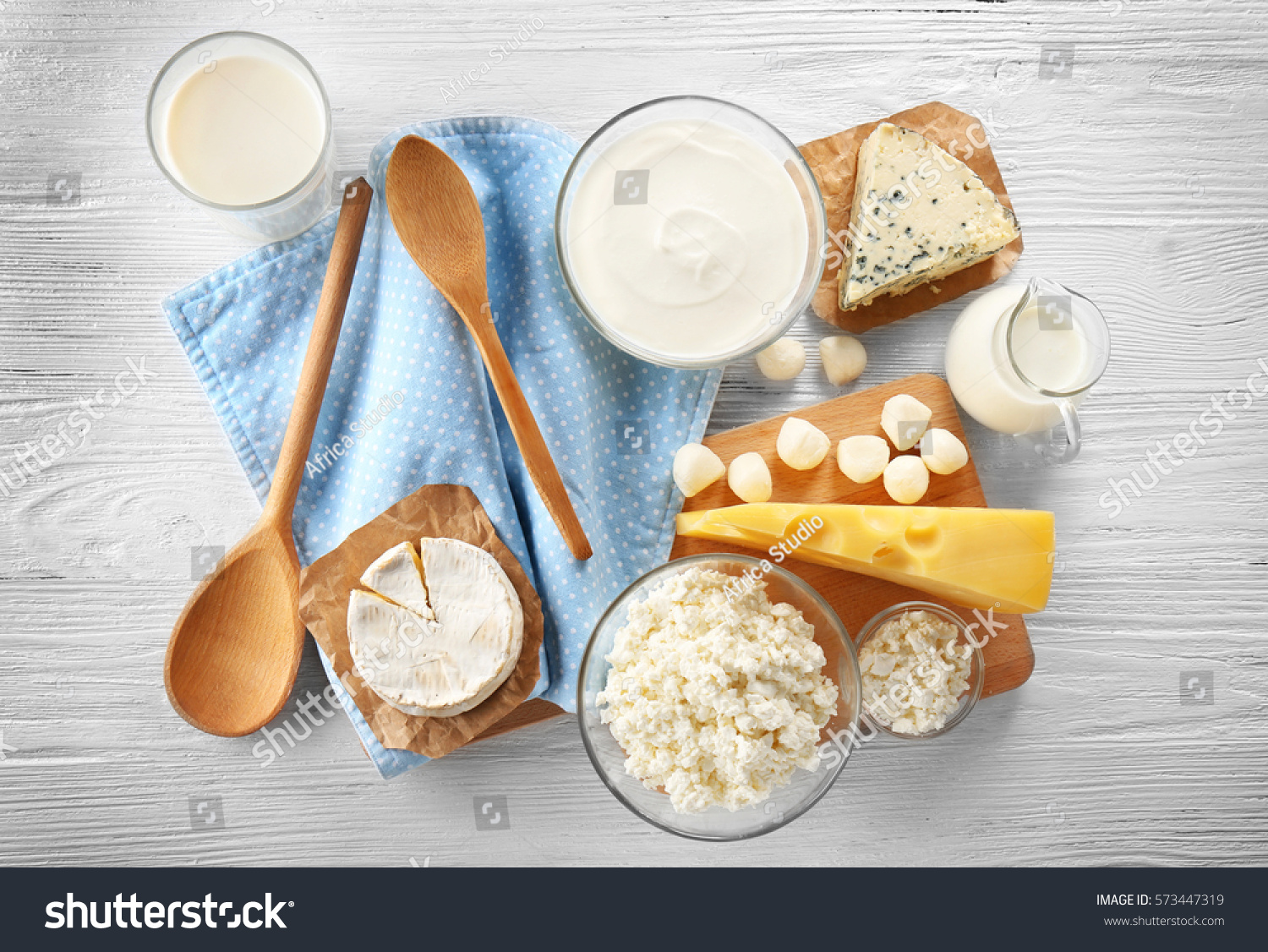 Different types of dairy products on wooden background #573447319