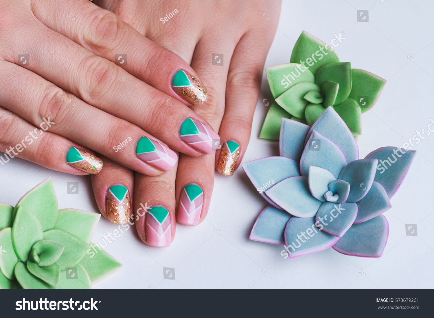 Nail art with bright gold, pink and green chevron pattern on light background #573679261