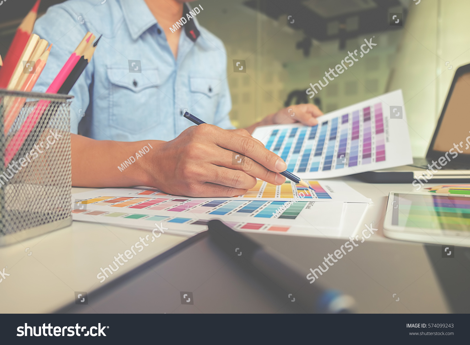 Graphic design and color swatches and pens on a desk. Architectural drawing with work tools and accessories. #574099243