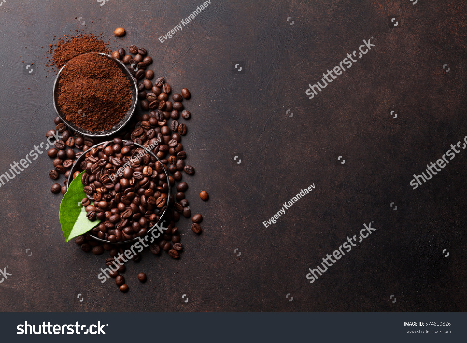 Coffee beans and ground powder on stone background. Top view with copy space for your text  #574800826