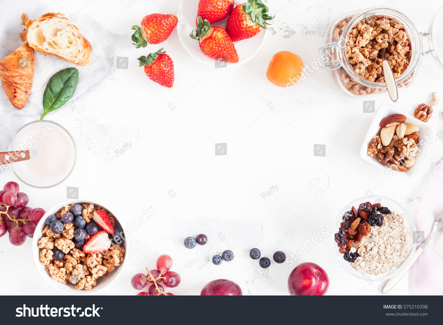 Healthy breakfast with muesli, fruits, berries, nuts on white background. Flat lay, top view, copy space. #575210398