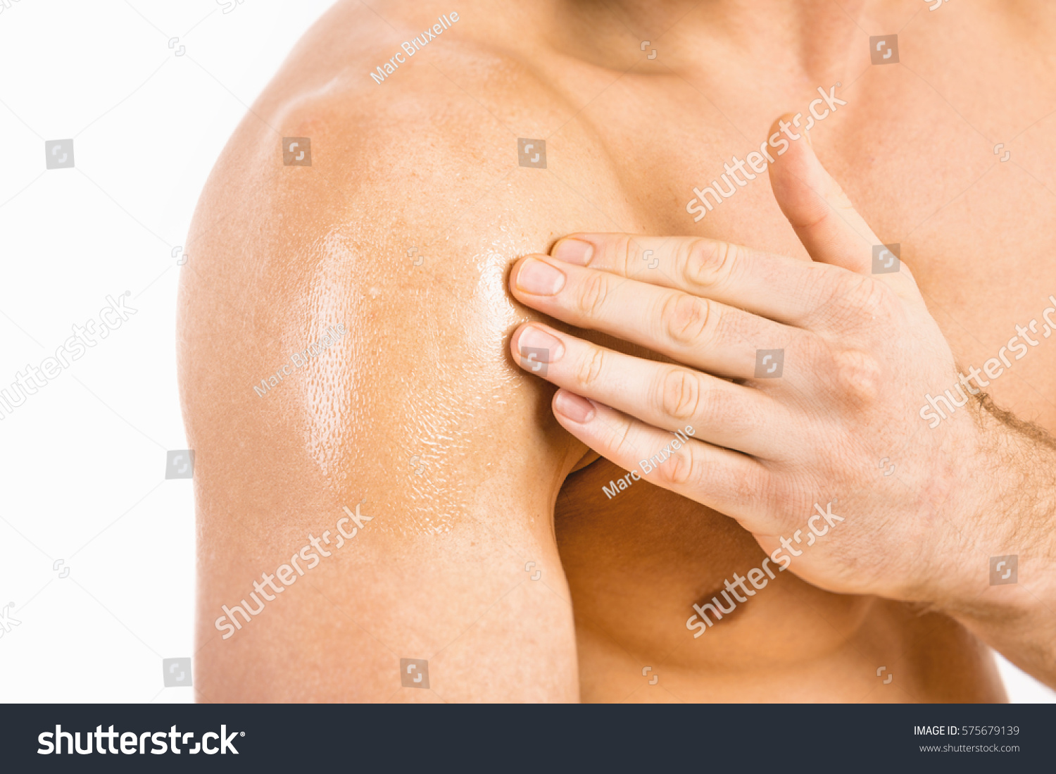 Testosterone Replacement Therapy (TRT) - Muscular man applying testosterone gel on shoulder #575679139