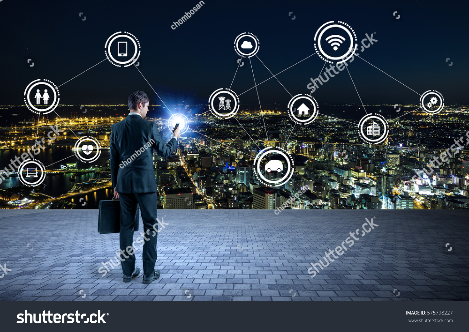 businessman holding smart phone and Internet of Things concept, smart city, wireless communication network, Information Communication Technology, abstract image visual #575798227