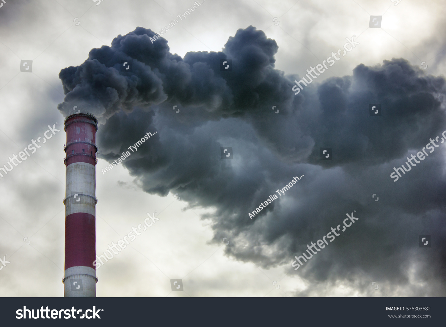Air pollution, closeup of one big smoking pipe #576303682