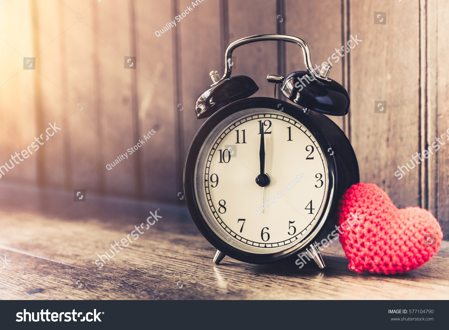 Love clock vintage tone timed 12 o'clock, Time of sweet loving past memories story on the old wood background. #577104790