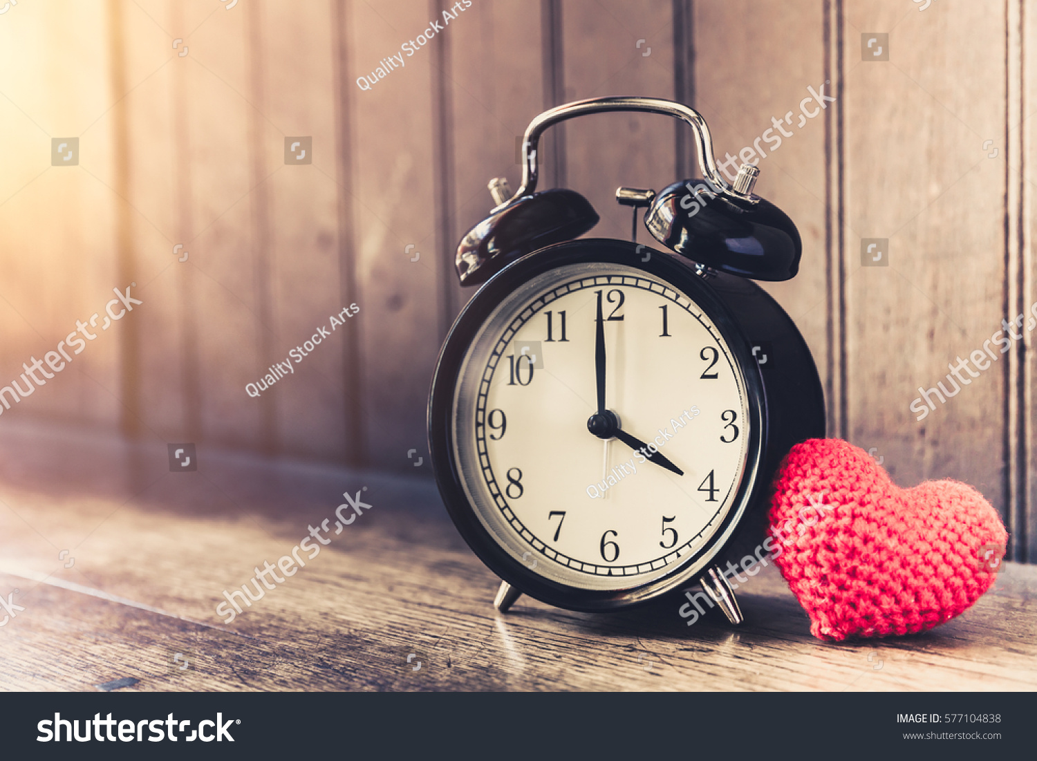 Love clock vintage tone timed 4 o'clock, Time of sweet loving past memories story on the old wood background. #577104838