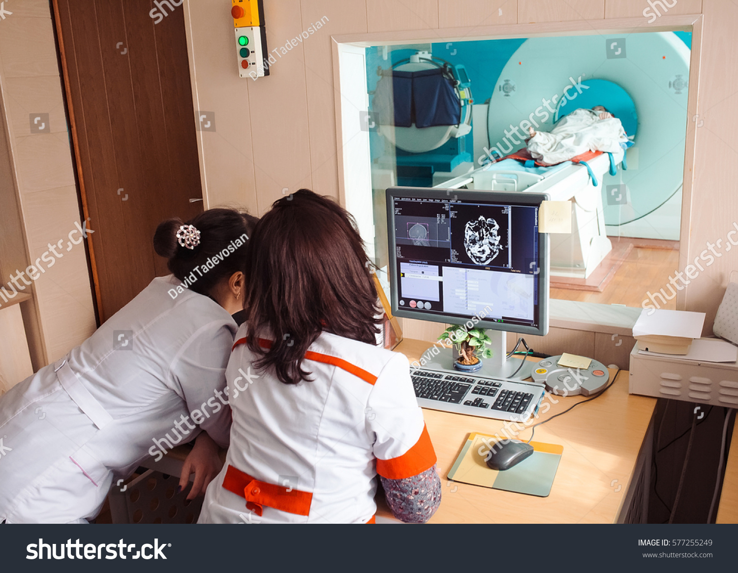 MRI machine and screens with doctor and nurse #577255249